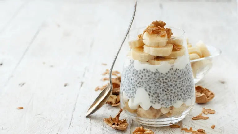 Chia seed breakfast bowl topped with fresh berries, banana slices and shredded coconut