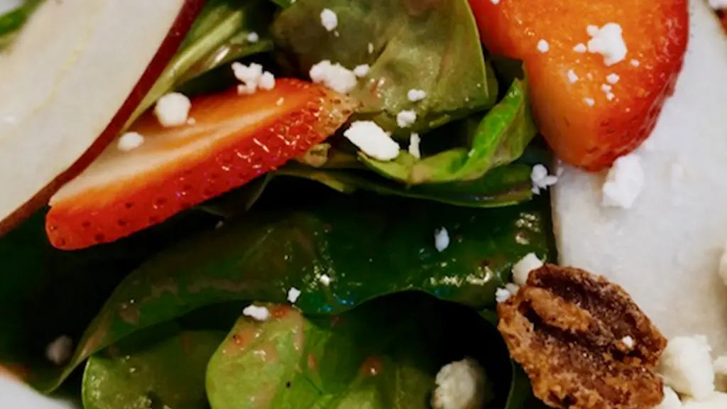 Fruit and nut salad with torn lettuce, chopped pear, mandarin oranges, feta cheese and candied pecans