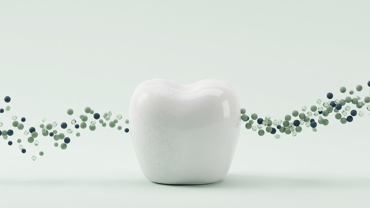 A tooth with minerals leaving on one side and returning on the other, illustrating how to remineralize teeth