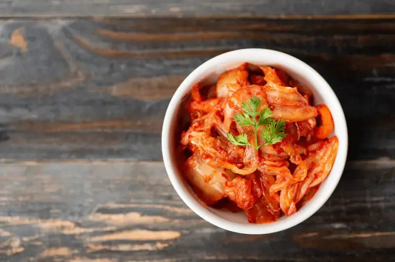 A jar of homemade Korean kimchi made with napa cabbage, radish, and gochugaru