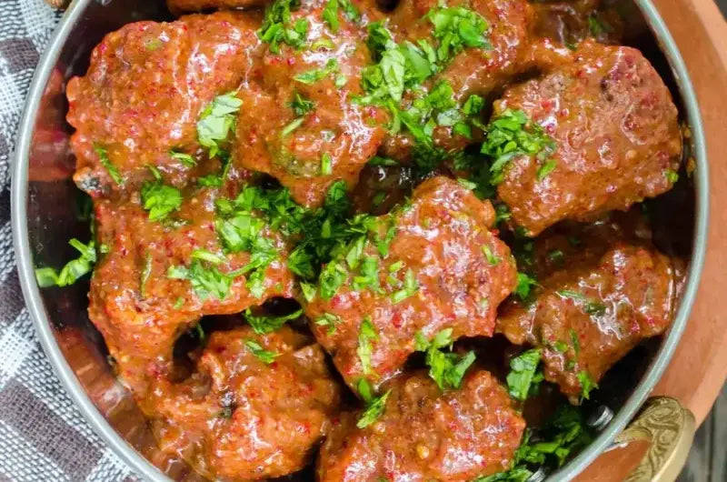 Bowl of Rogan Josh, Indian lamb curry in a deep red spiced sauce, served with rice