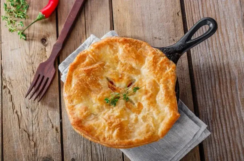 Sourdough chicken pot pie baked in a skillet with a golden sourdough biscuit topping