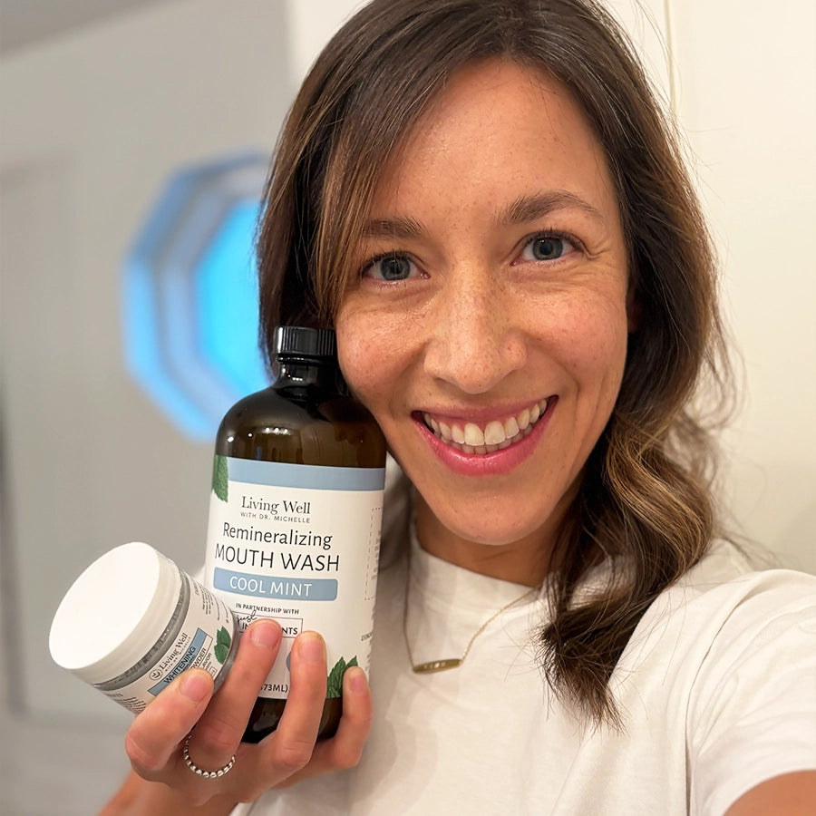 woman holding remineralizing mouthwash - fluoride free